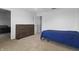 Bedroom with carpet and a dark wood dresser and blue comforter at 10312 Gladeview Dr, Indianapolis, IN 46239