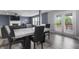 A modern dining room featuring a fireplace, patio doors, and a designer table at 10312 Gladeview Dr, Indianapolis, IN 46239