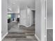 An airy hallway with hard surface floors and a view into the dining room at 10312 Gladeview Dr, Indianapolis, IN 46239