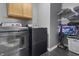 Laundry room with side-by-side washer and dryer, shelving, and overhead cabinets at 10312 Gladeview Dr, Indianapolis, IN 46239