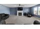 Cozy living room featuring a fireplace, ceiling fan, and modern furnishings at 10312 Gladeview Dr, Indianapolis, IN 46239