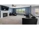 Bright living room with a fireplace and large windows overlooking the backyard at 10312 Gladeview Dr, Indianapolis, IN 46239