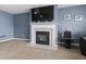 Living room featuring a fireplace with a mantel and modern decor at 10312 Gladeview Dr, Indianapolis, IN 46239