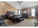 This main bedroom features a tufted leather bed frame, ceiling fan and multiple windows at 10312 Gladeview Dr, Indianapolis, IN 46239