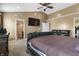 This main bedroom includes a television, ceiling fan, carpet and ensuite bathroom at 10312 Gladeview Dr, Indianapolis, IN 46239