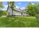 Wide shot of backyard with lush green grass and mature trees surrounding the home at 10398 Ethel St, Carmel, IN 46280