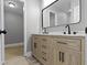 Bathroom features a wood double vanity with dual sinks, marble countertop, and modern fixtures at 10398 Ethel St, Carmel, IN 46280