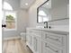 Bathroom features a white vanity, a black framed mirror and a large arched window at 10398 Ethel St, Carmel, IN 46280