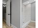 Modern walk-in shower featuring marble-style tile and glass enclosure at 10398 Ethel St, Carmel, IN 46280