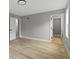 Spacious bedroom with gray walls, white trim, light wood-look floors, and bright windows at 10398 Ethel St, Carmel, IN 46280