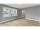 Bright bedroom with a large window and wood-look floors, freshly painted in neutral gray at 10398 Ethel St, Carmel, IN 46280