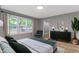 Beautiful bedroom with green and gray decor, neutral walls, and floor to ceiling windows at 10398 Ethel St, Carmel, IN 46280