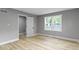 Bedroom with a view, showcasing wood-look floors and a connecting door to another room at 10398 Ethel St, Carmel, IN 46280