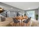 Open-concept dining area with stylish table set and views into the kitchen and living room at 10398 Ethel St, Carmel, IN 46280