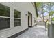Exterior side view of home with back porch and trees; side entrance door at 10398 Ethel St, Carmel, IN 46280