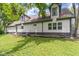 Back exterior view of home with yard, showing neutral siding and dark trim at 10398 Ethel St, Carmel, IN 46280