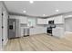 Modern kitchen features new appliances, white cabinets, and hardwood floors at 10398 Ethel St, Carmel, IN 46280