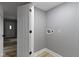 A compact laundry area, featuring modern hookups and freshly painted walls, and wood-look floors at 10398 Ethel St, Carmel, IN 46280