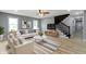 Cozy living room with a modern sofa, sleek stairs, and a ceiling fan at 10398 Ethel St, Carmel, IN 46280