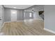 Bright living room featuring newly finished floors with views of entry, stairs, and kitchen at 10398 Ethel St, Carmel, IN 46280