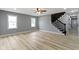 Spacious living room showcasing hardwood floors and staircase at 10398 Ethel St, Carmel, IN 46280