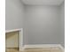Cozy room with gray walls, white trim, wood floor, and a niche for all your personal touch at 10398 Ethel St, Carmel, IN 46280