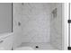 New shower with white marble-look tile, niche, white penny tile floor, and modern hardware at 10398 Ethel St, Carmel, IN 46280