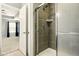 Bathroom featuring a tiled shower stall with glass door and chrome fixtures at 10606 Glenwyck Pl, Noblesville, IN 46060