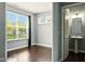 Bedroom with a large window and attached bathroom with a pedestal sink at 10606 Glenwyck Pl, Noblesville, IN 46060