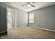 Bedroom with neutral carpet and gray walls, featuring a ceiling fan and window at 10606 Glenwyck Pl, Noblesville, IN 46060