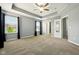 The spacious bedroom includes tray ceilings, a ceiling fan, and neutral walls to easily match your decor at 10606 Glenwyck Pl, Noblesville, IN 46060