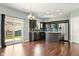 Modern kitchen with dark cabinets, stainless steel appliances, and a view of the backyard at 10606 Glenwyck Pl, Noblesville, IN 46060