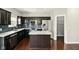 Modern kitchen features stainless steel appliances, granite countertops, a kitchen island, and dark cabinets at 10606 Glenwyck Pl, Noblesville, IN 46060