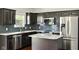 Modern kitchen features stainless steel appliances, granite countertops, and dark cabinets at 10606 Glenwyck Pl, Noblesville, IN 46060