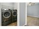 Laundry room with new front-load washer and dryer in a compact space at 10606 Glenwyck Pl, Noblesville, IN 46060