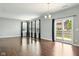 Spacious living room with dark wood floors and a sliding glass door to the backyard at 10606 Glenwyck Pl, Noblesville, IN 46060
