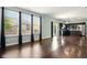 Spacious living room with dark wood floors, and a view of the kitchen at 10606 Glenwyck Pl, Noblesville, IN 46060