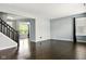 Open living room with dark wood floors and view of the front and back yards at 10606 Glenwyck Pl, Noblesville, IN 46060
