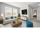 Bright living room with a modern sofa, decorative pillows, and large windows providing lots of natural light at 10606 Glenwyck Pl, Noblesville, IN 46060