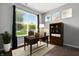 Bright office with a large window, dark wood floors, a desk, and a bookshelf at 10606 Glenwyck Pl, Noblesville, IN 46060