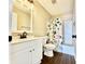 Charming bathroom featuring a vanity with a black faucet, decorative shower curtain, and updated fixtures at 10900 Clear Spring Dr, Camby, IN 46113