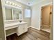 Light and bright bathroom with vinyl flooring, tub, shower, and vanity sink at 10900 Clear Spring Dr, Camby, IN 46113