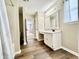 Bathroom boasting a vanity with sink, a window, tub-shower combo, and hardwood floors at 10900 Clear Spring Dr, Camby, IN 46113