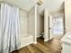 This bathroom features a combined tub and shower with hard surface flooring and an entrance to the bedroom at 10900 Clear Spring Dr, Camby, IN 46113