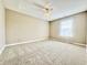 Cozy bedroom with plush carpet, a ceiling fan, and a bright window creating a tranquil atmosphere at 10900 Clear Spring Dr, Camby, IN 46113