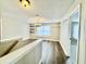 Bright dining area with wood floors, modern chandelier, floating shelves, and a window at 10900 Clear Spring Dr, Camby, IN 46113