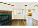 Open-concept living room with fireplace, new floors, and views of the kitchen at 10900 Clear Spring Dr, Camby, IN 46113