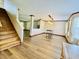 Open-concept living space with staircase, new floors, and views of the kitchen at 10900 Clear Spring Dr, Camby, IN 46113