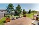 Brick patio features outdoor seating, a grill, and views of the landscaped backyard at 10900 Clear Spring Dr, Camby, IN 46113