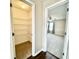 A walk-in closet with multiple metal shelves and an adjacent bedroom boasting neutral walls and plush carpet at 10900 Clear Spring Dr, Camby, IN 46113